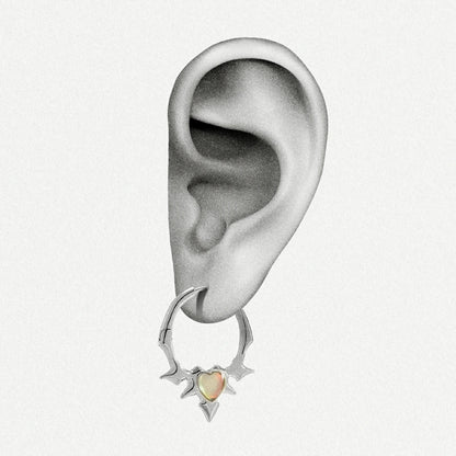 Silver-tone spiked hoop earring with an opal heart center worn on an ear illustration