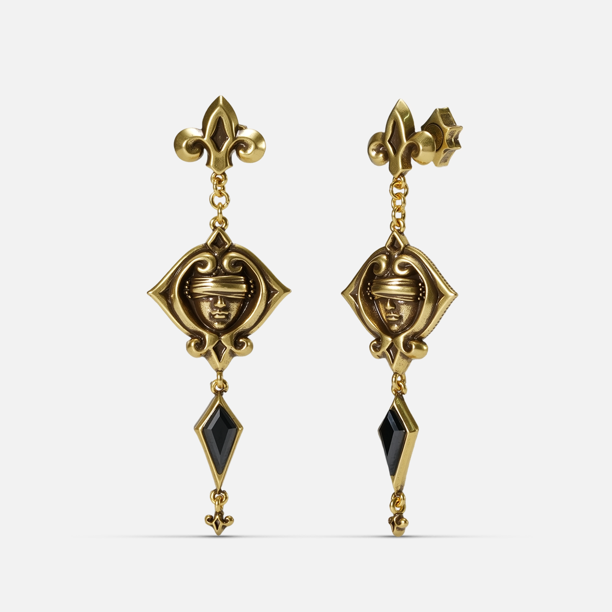 Gold-tone Blind Oracle Drop Earrings shown from front and side views with blindfolded face motifs and faceted black zircon drops.