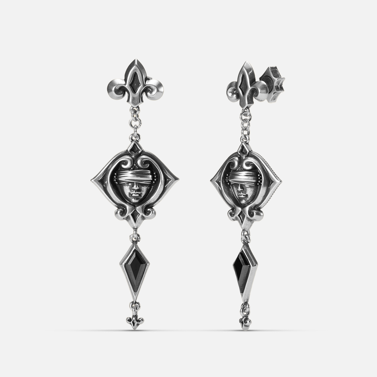 Antiqued silver-tone Blind Oracle Drop Earrings shown from front and side views with blindfolded face motifs and faceted black zircon drops.