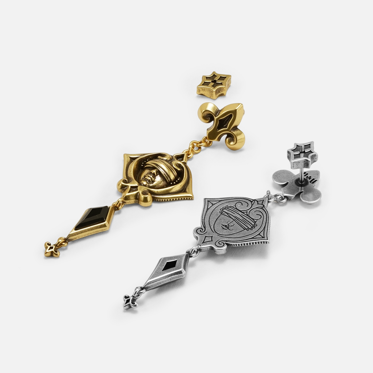 Antiqued silver- and gold-tone Blind Oracle Drop Earrings displayed from angled views to show their layered construction.