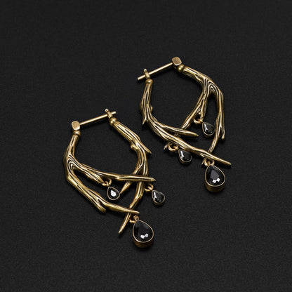 Pair of gold Blood Thorn hoop earrings with branching frames and dark red drops