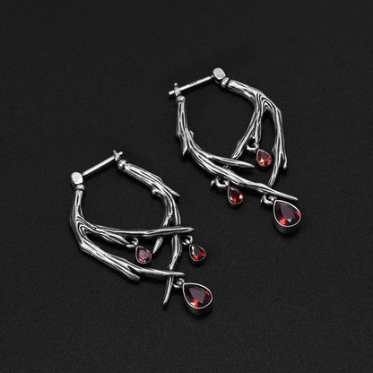 Pair of silver Blood Thorn hoop earrings with branching frames and red drops