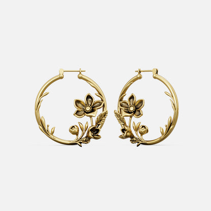 Pair of gold-tone hoop earrings featuring a vine and flower design, shown against a plain background