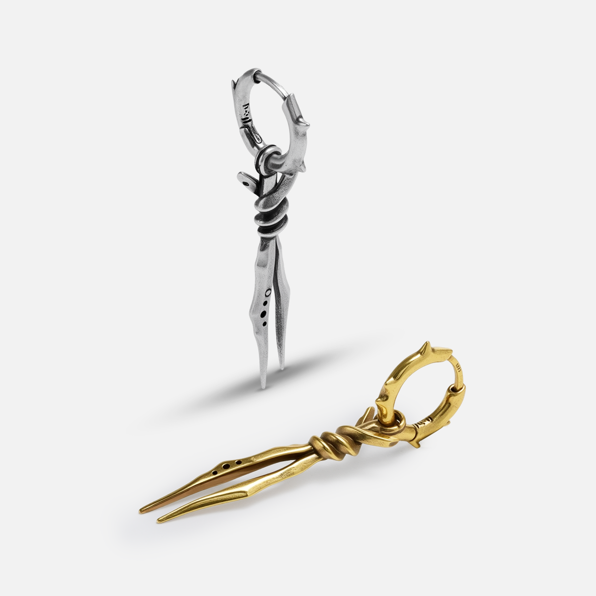 Bound Twin Earrings shown in silver and gold tones with twin spike pendant design
