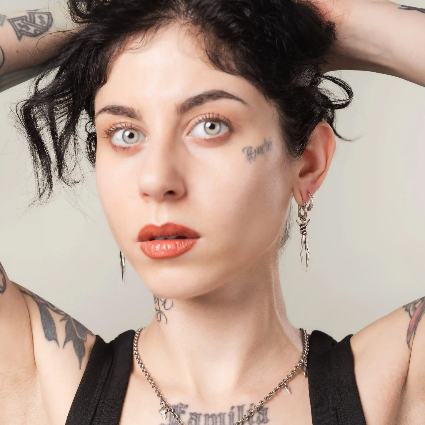 Model wearing silver Bound Twin Earrings with ritual-inspired twin spike design