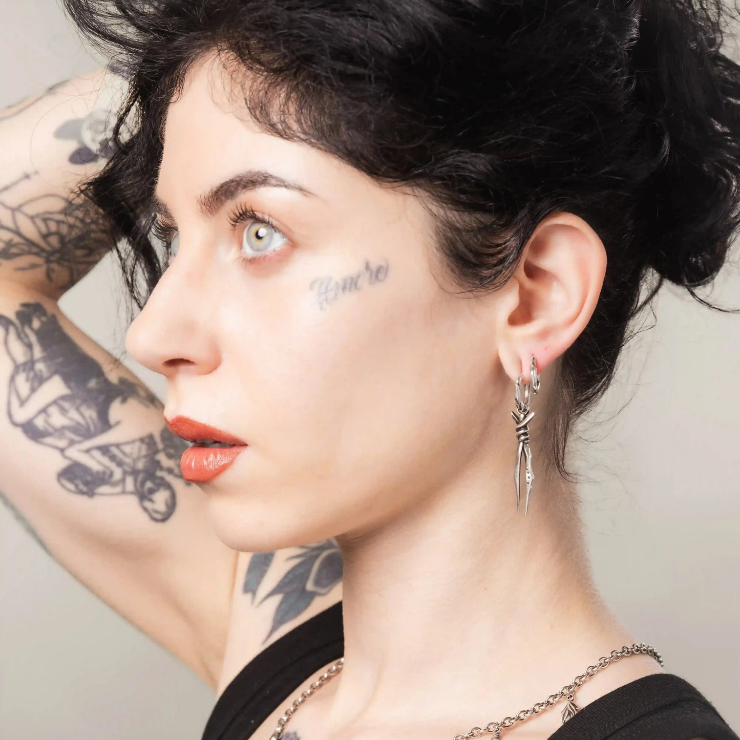 Silver Bound Twin Earrings styled on model with long spike drop silhouette and gothic jewelry mood