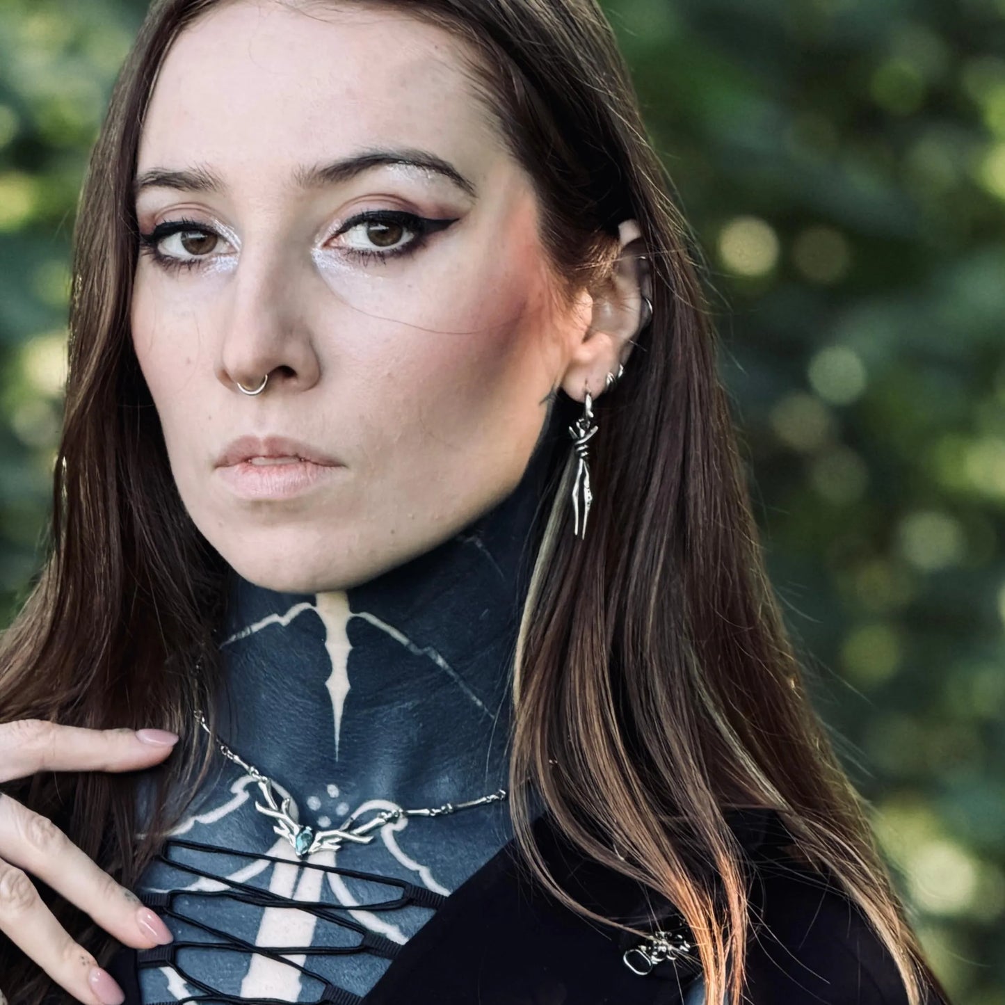 Model wearing the silver Bound Twin Earrings with two slim spike drops, twisted wire details, and dark forest-inspired gothic styling.