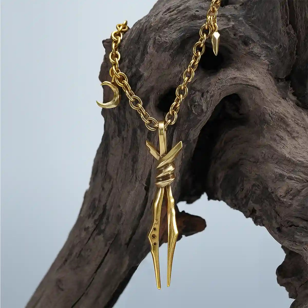 Gold Bound Twin Necklace displayed on driftwood with long twin spike pendant detail