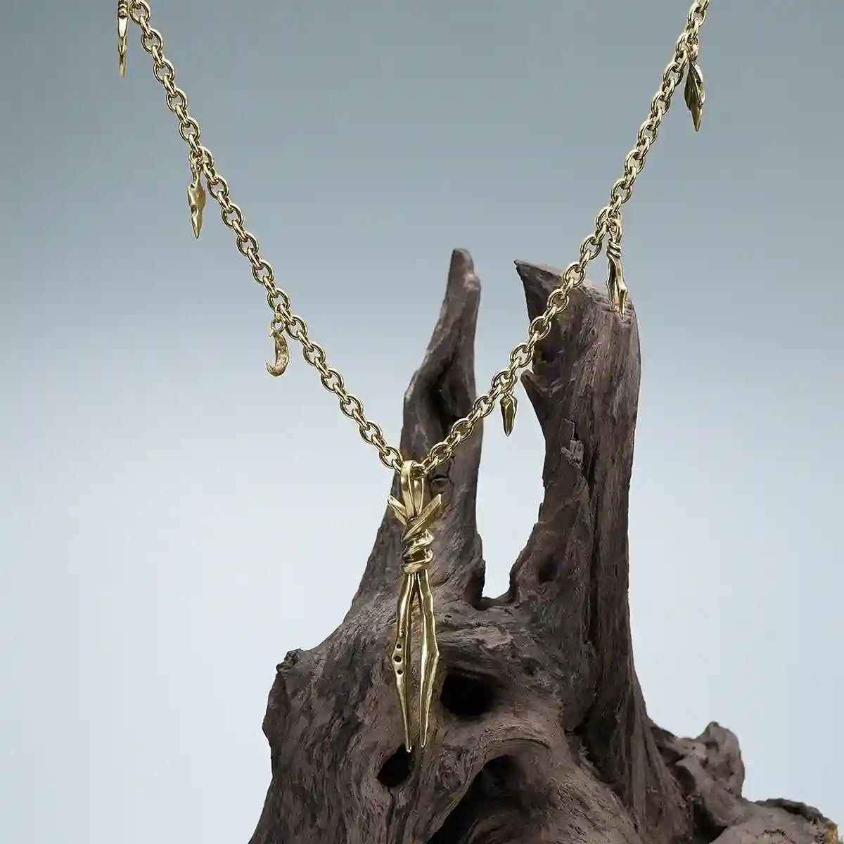 Gold Bound Twin Necklace displayed on weathered wood with ritual relic inspired styling