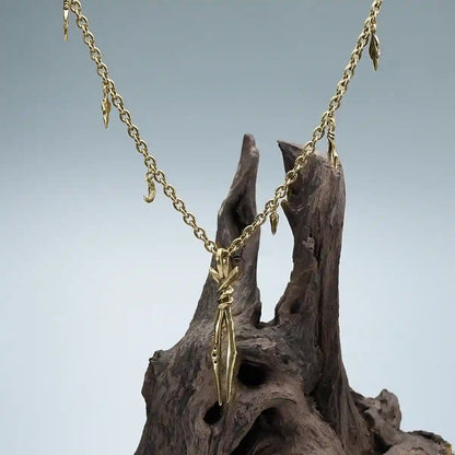 Gold Bound Twin Necklace displayed on weathered wood with ritual relic inspired styling