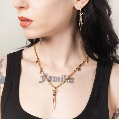 Gold Bound Twin Necklace styled on model with ritual spike pendant and antiqued finish