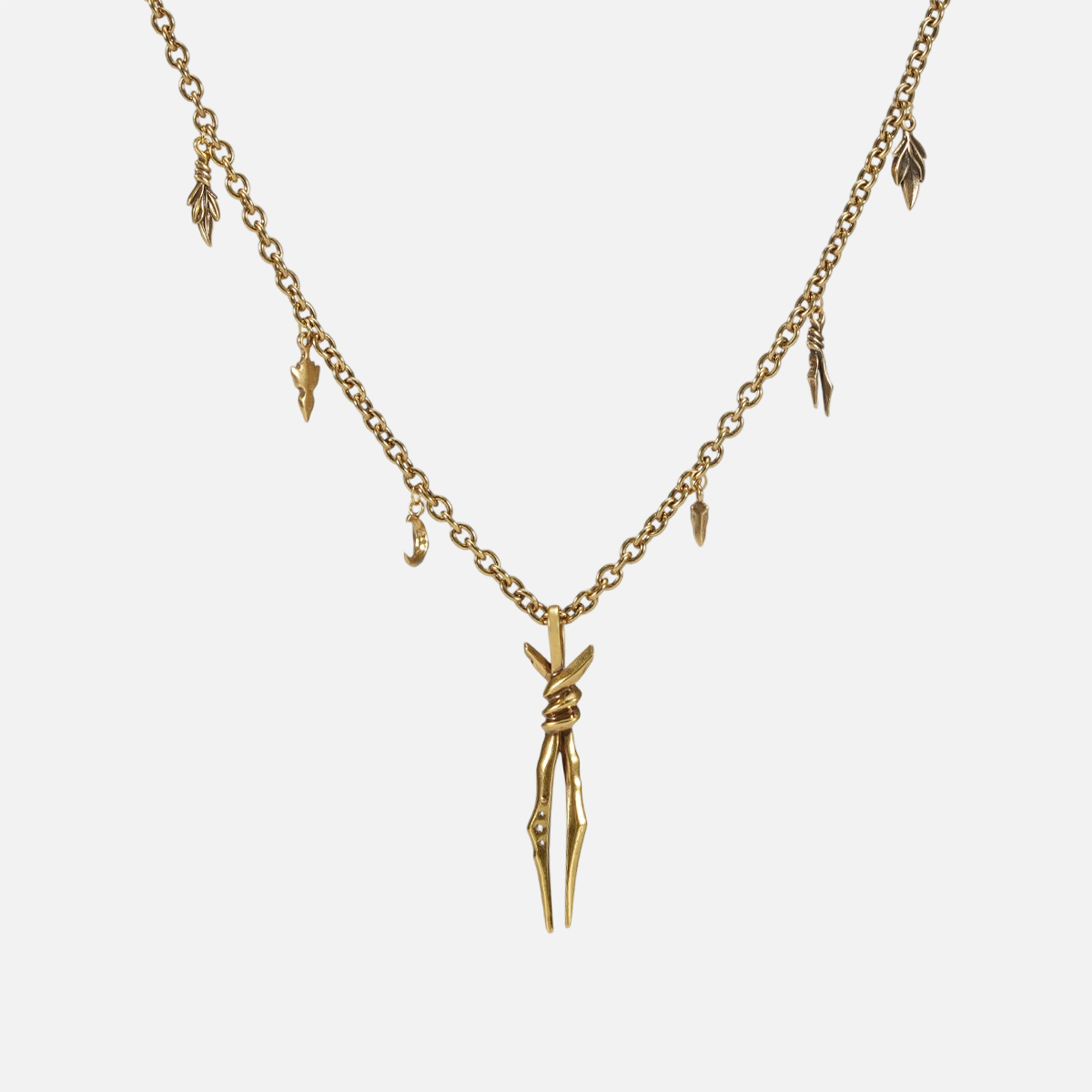 The gold-tone Bound Twin Necklace features a twin spike pendant and an antiqued charm chain.
