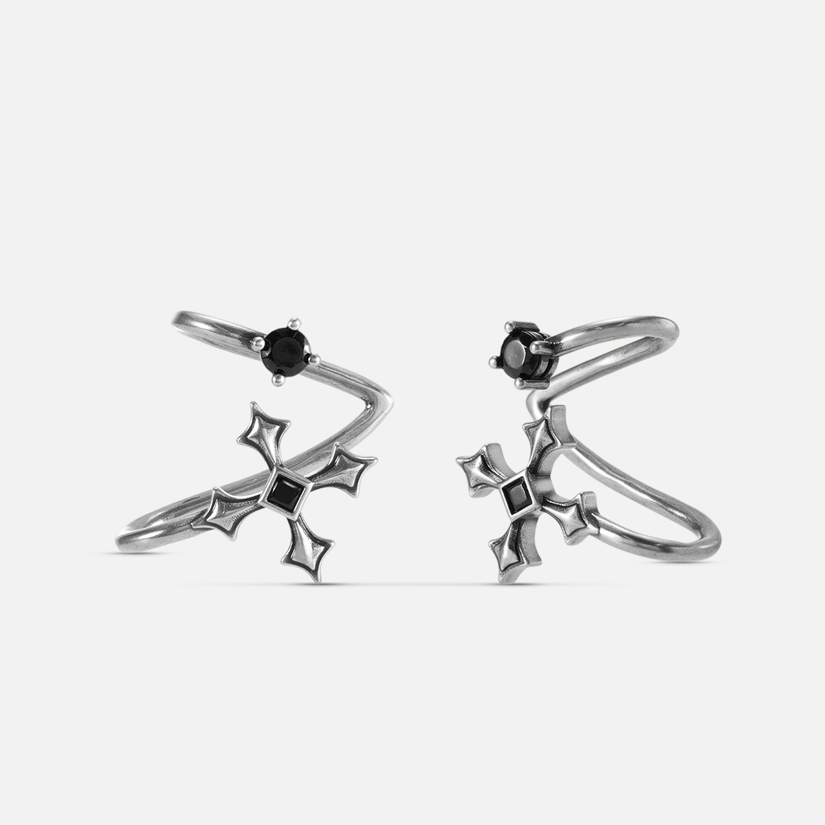 Bound Vestige Ear Cuffs in antiqued silver with black obsidian and cross-inspired metalwork on a white background.