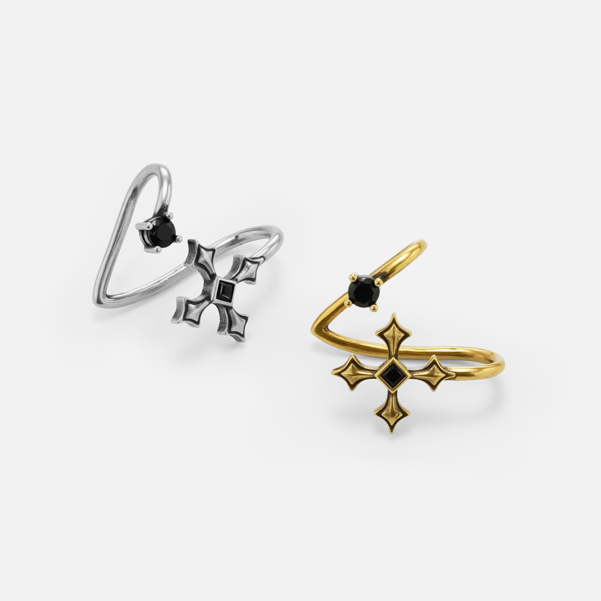 Bound Vestige Ear Cuffs in silver and gold shown at angled side views on white, highlighting the cuff openings and black obsi