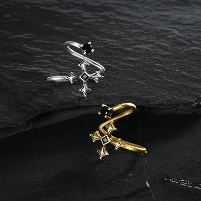 Silver and gold Bound Vestige Ear Cuffs arranged at opposing angles on black textured fabric.