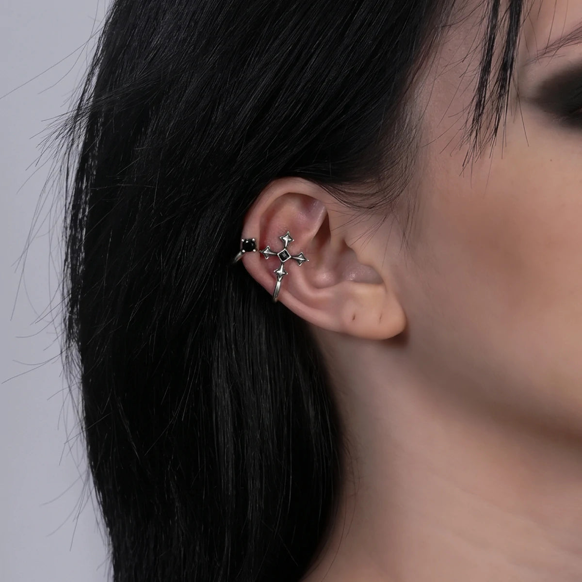 Bound Vestige Ear Cuffs in antiqued silver worn on the upper ear in a close side-profile crop with dark hair.