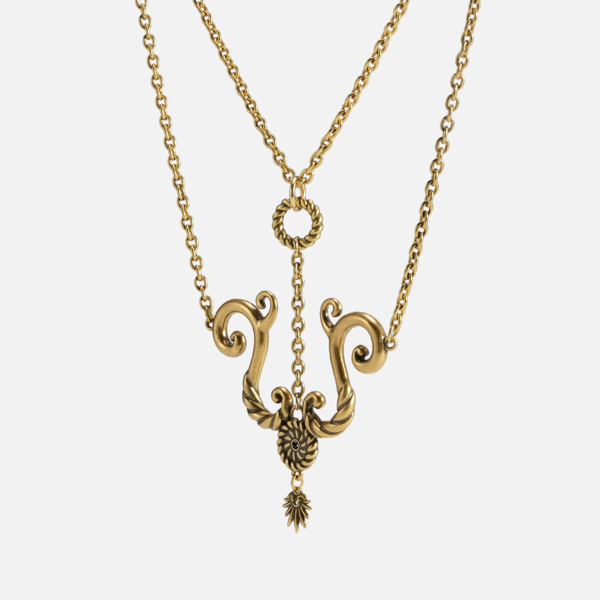 Layered brass rope textured ring necklace with detailed curved spiral form