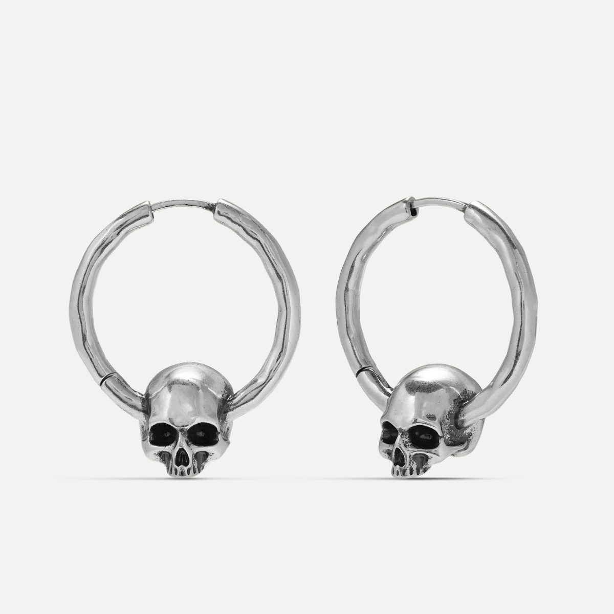 Brave skull earrings in silver, shown as a pair in a front view with skull charm details
