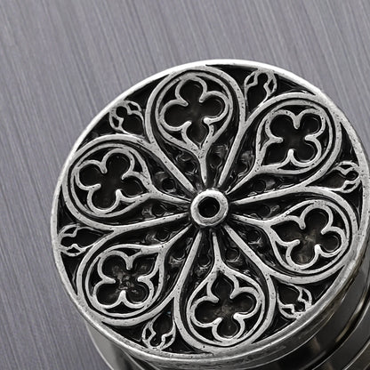Close-up of silver Cathedral Rose plug with circular window tracery design