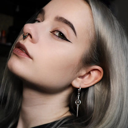 Celestial Orbit Earrings in 925 sterling silver, worn in a blonde side portrait with a black top and clean winged eyeliner.