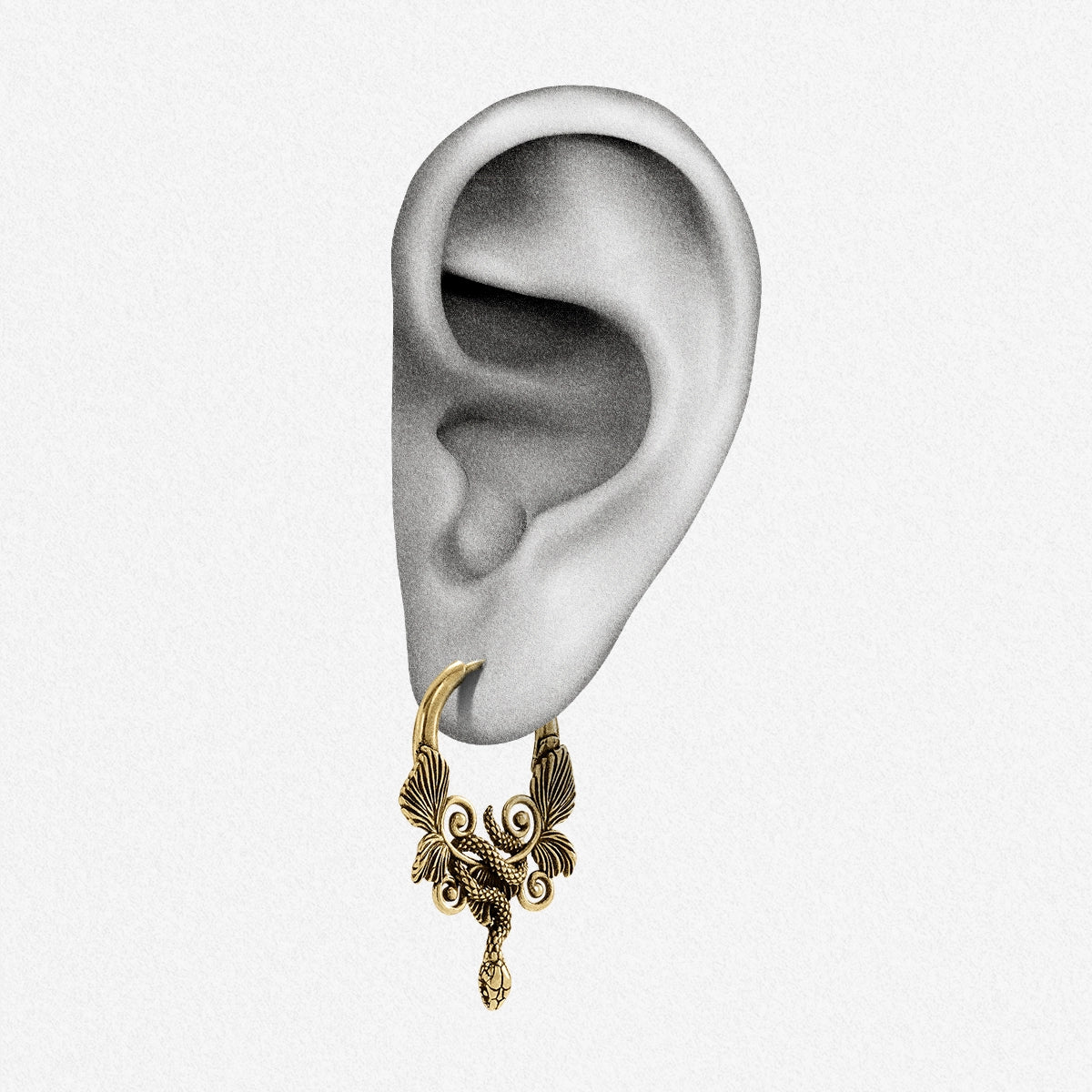 Illustrated ear model wearing a gold-tone serpent hoop earring with wing accents