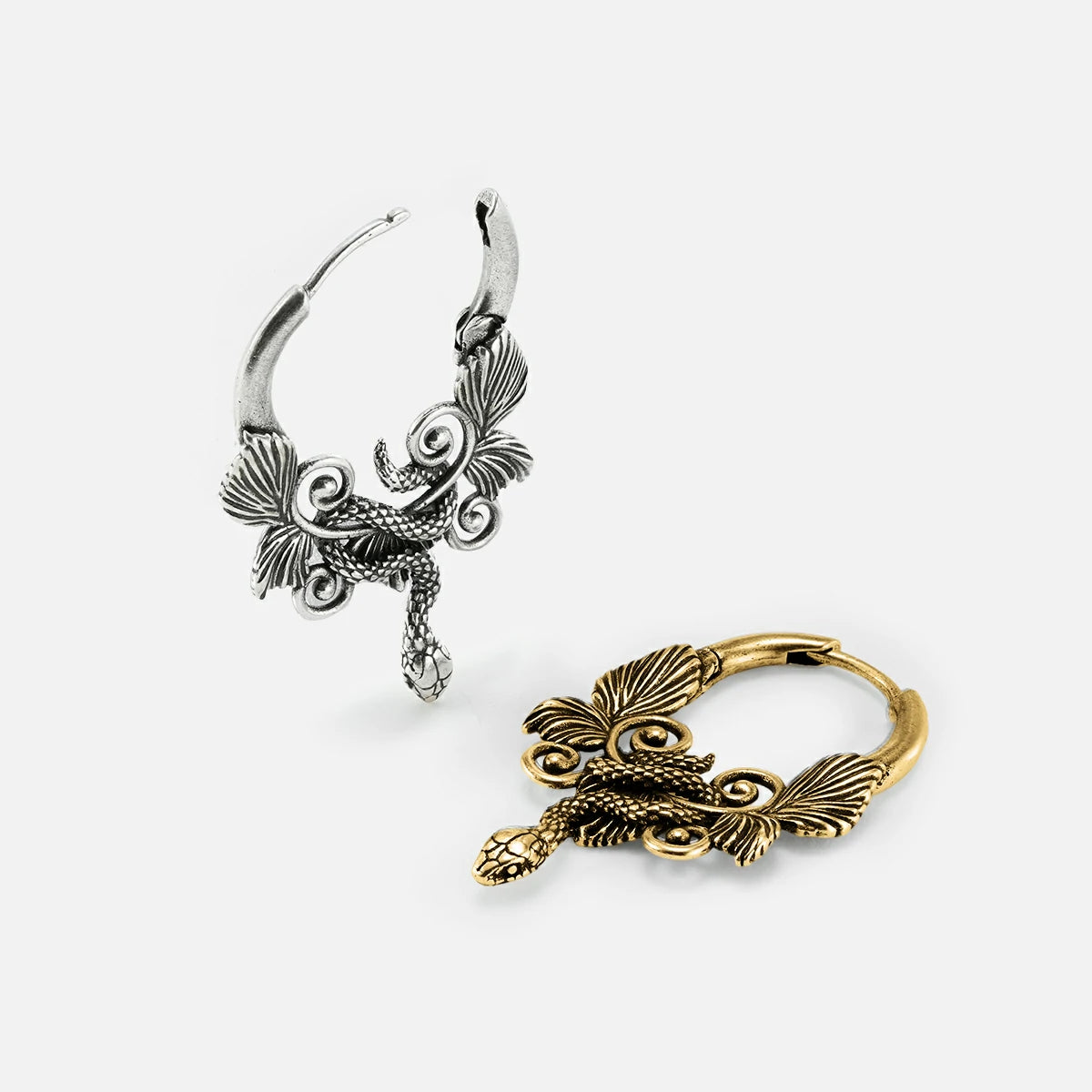 Silver-tone and gold-tone serpent hoop earrings shown side by side, highlighting the wing and coil details