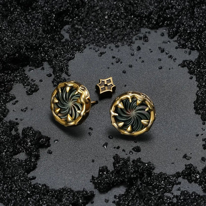 Gold Charybdis Maw Ear Studs displayed on black sand, featuring abalone shell spiral centers, tooth-like rims, and ocean relic mood.