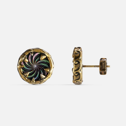 Gold Charybdis Maw Ear Studs with abalone shell spiral center, carved tooth-like rim, textured side detail, and flat back post on a clean background.