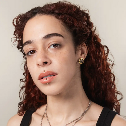Model wearing PUNKYOUTH Charybdis Maw stud earrings inspired by mythology and ocean whirlpools