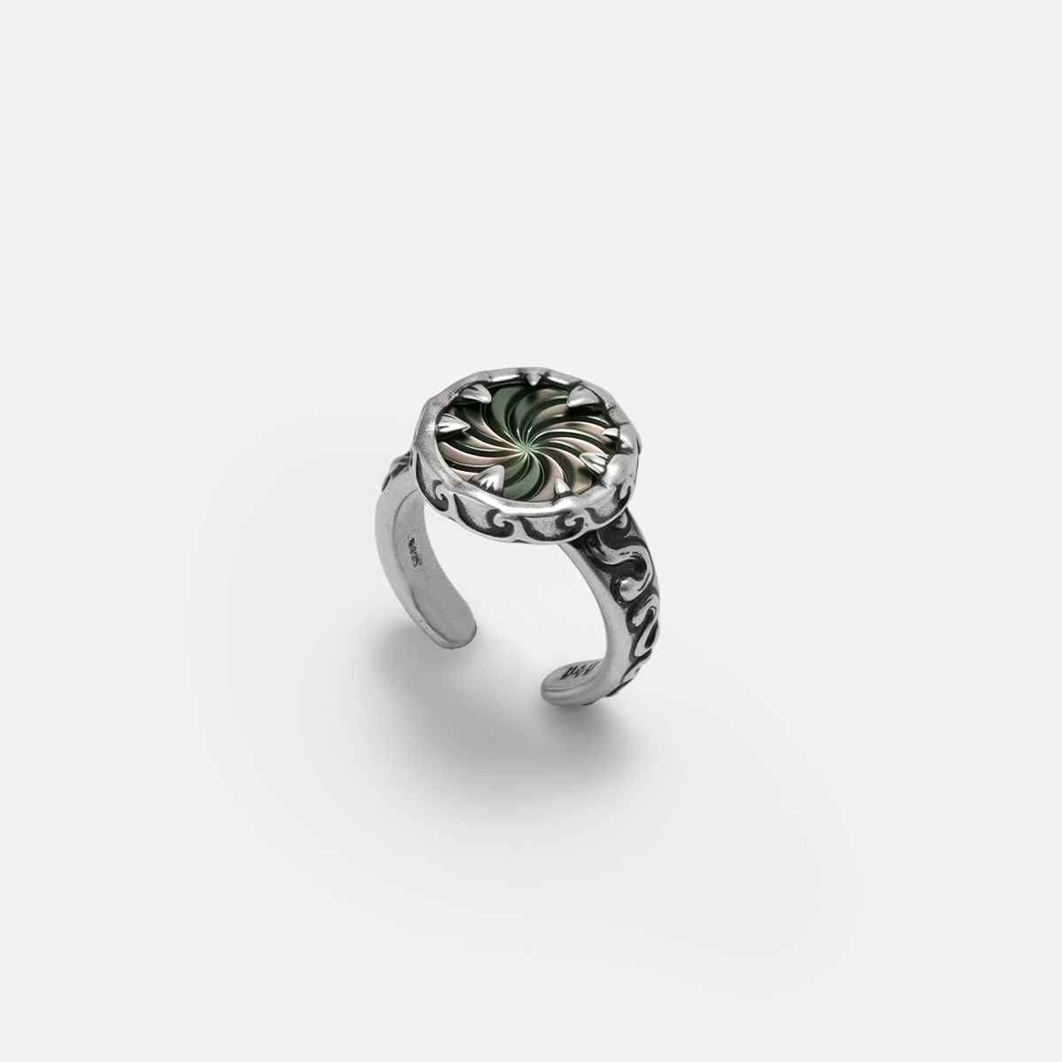 Charybdis Maw Ring in antiqued silver with swirling abalone shell center, carved wave-like edges, and open ring design on a clean background.