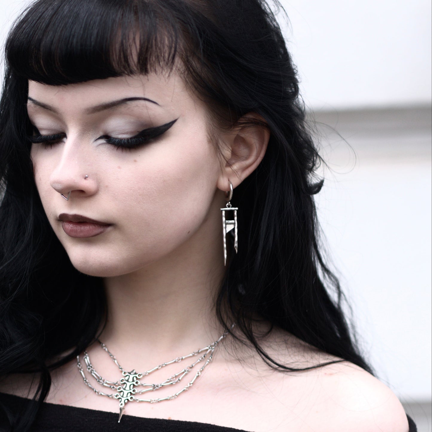 925 silver Chic Guillotine earrings worn by a model with black hair, shown in a front three-quarter view