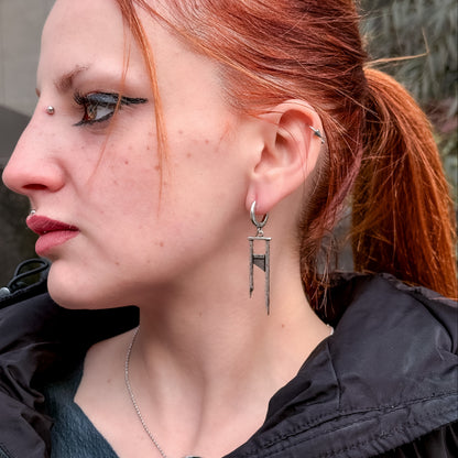 925 silver Chic Guillotine earring worn on a model, close side view of the long geometric blade drops