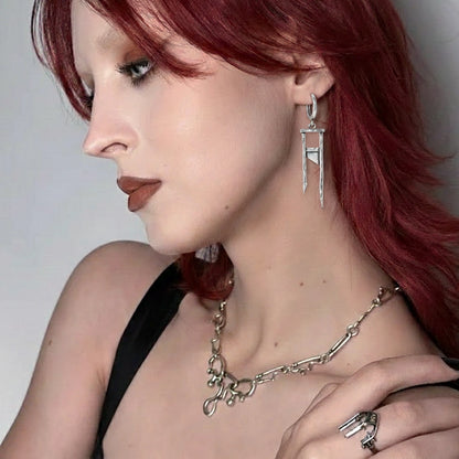 925 silver Chic Guillotine earring worn by a model with red hair, paired with a layered silver-tone necklace