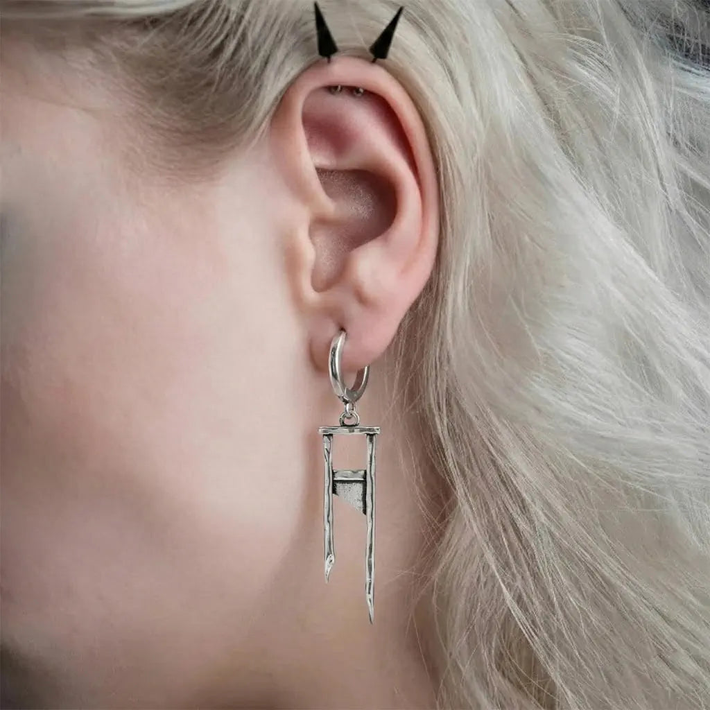 Chic Guillotine Earrings in 925 sterling silver, worn in a close ear view with platinum hair, showing the long guillotine dro