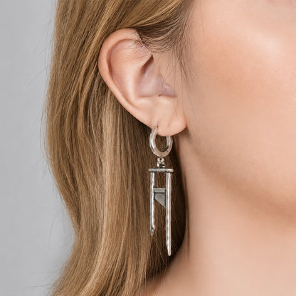 Silver-tone hoop earring featuring a hammered guillotine-shaped pendant, worn on model's ear