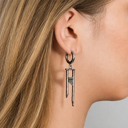 Oxidized silver-tone hoop earring with a textured guillotine charm, shown on model's ear in profile