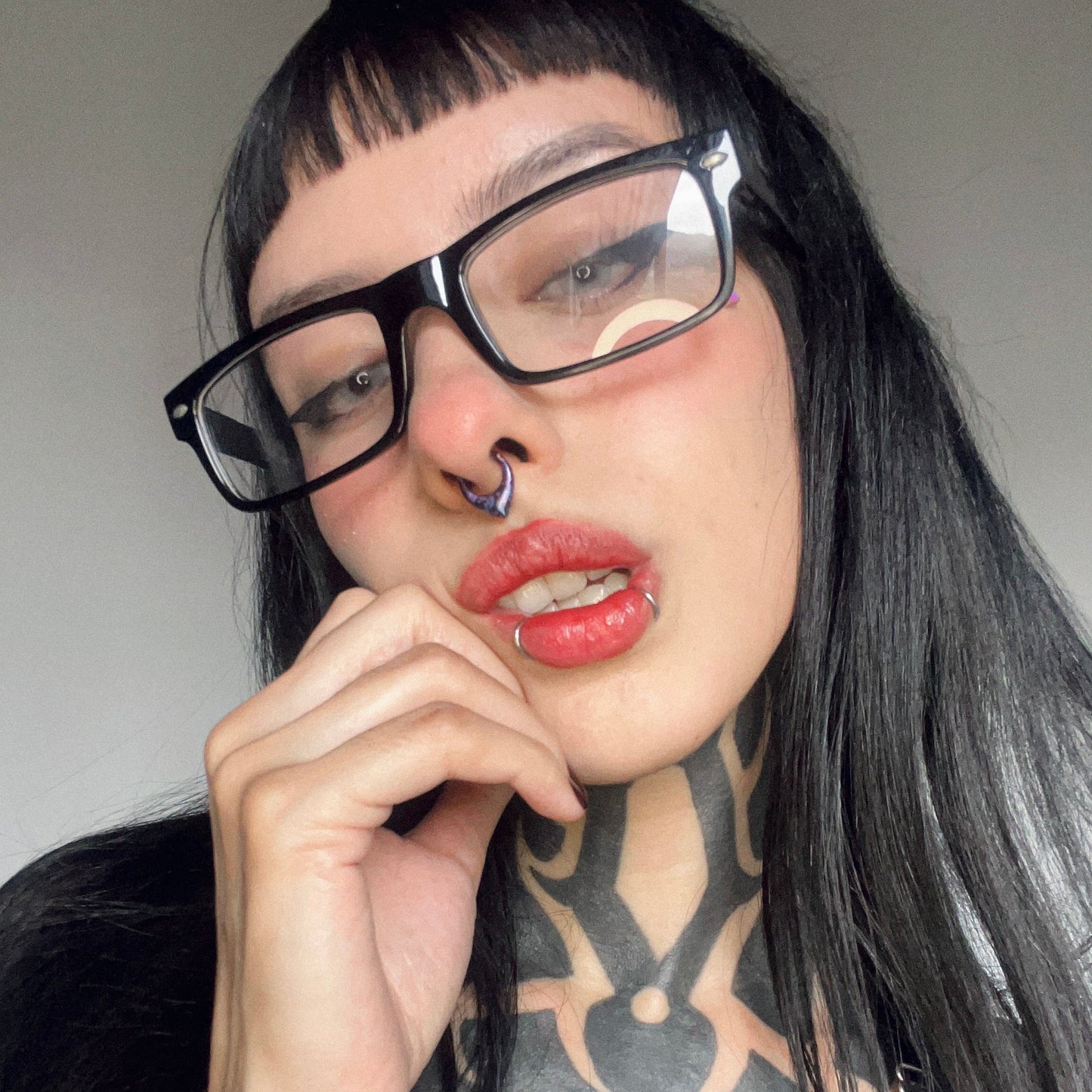 Model wearing a multicolor Chroma Wave titanium septum clicker