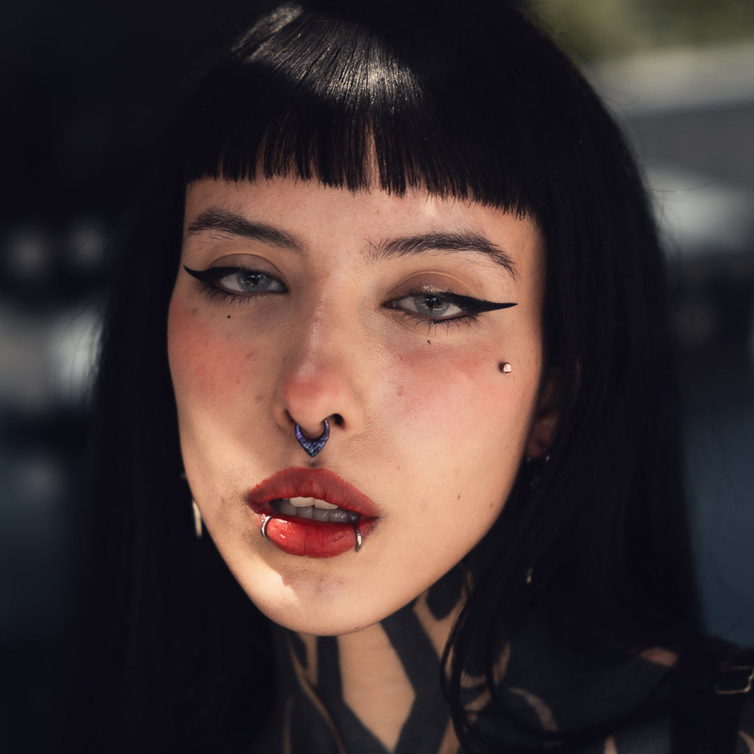 Close-up of model wearing a multicolor Chroma Wave titanium clicker