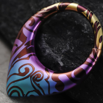Close-up of Chroma Wave titanium clicker with purple and aqua pattern