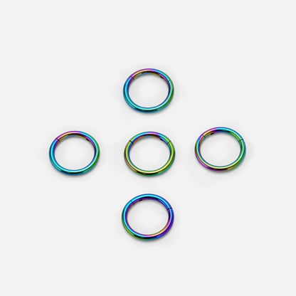 Five rainbow Chromatic Loop rings arranged on a white background