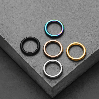 Black, rainbow, rose gold, gold, and silver Chromatic Loop rings displayed together