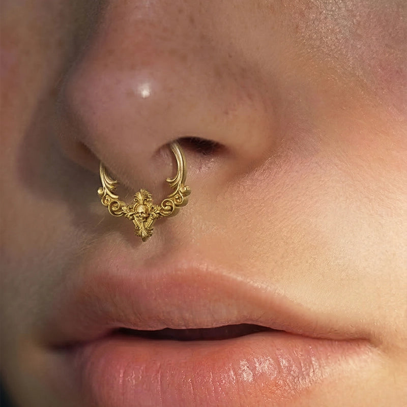 Gold Classical Phantasm clicker worn as a septum ring