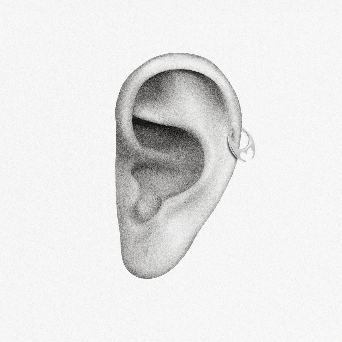 Silver Crescent Resolve Clicker shown on ear placement with sculptural crescent detail
