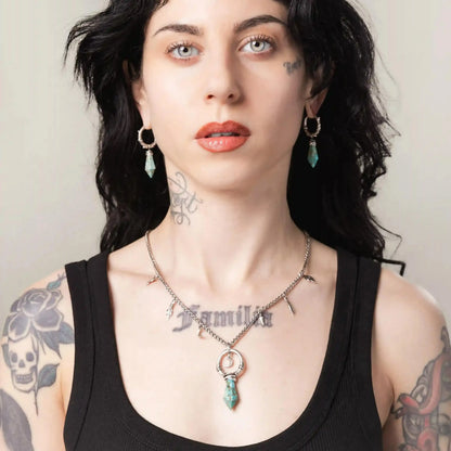 Silver Crescent Ward Necklace styled on model with crescent moon pendant and charm chain