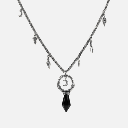 Silver Crescent Ward Necklace with black obsidian spike pendant, crescent moon charm, bone ring detail, and leaf-and-tooth chain accents on a clean background.