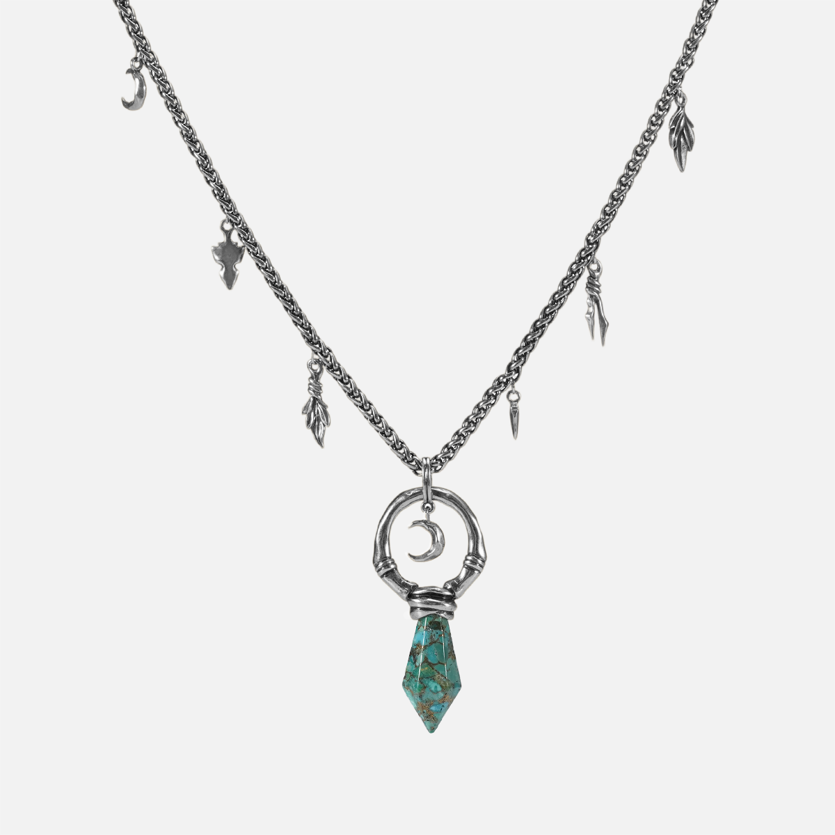 Crescent Ward Necklace in silver plating with crescent moon ring, turquoise spike pendant, and antiqued finish