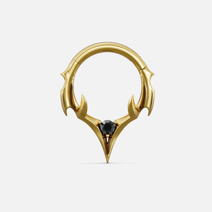 Gold-tone septum clicker ring with spiked crest design and a black center gemstone, front view