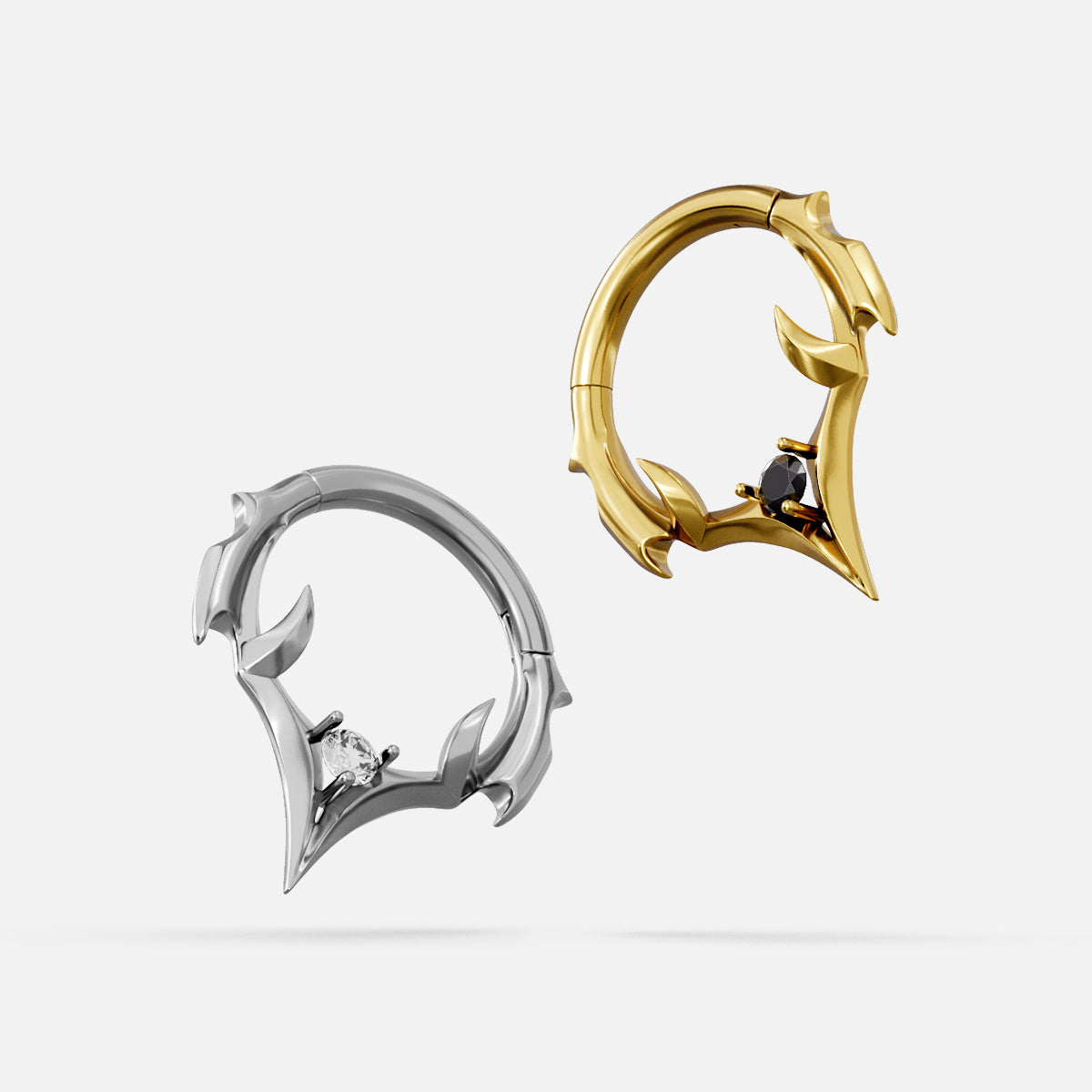 Silver and gold Crest Point clicker rings with black center accents