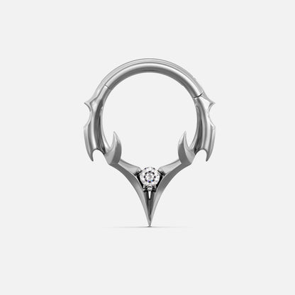 Silver-tone septum clicker ring with spiked crest design and a clear center gemstone, front view
