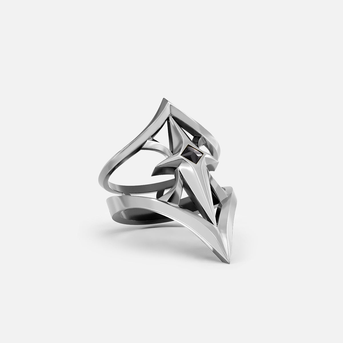 Silver-tone crest shield ring with pointed shield motif and small dark stone, shown at an angle